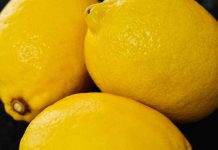 An up-close photo of pile of three lemons