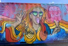 A brightly colored mural of a woman with flowing blonde hair enjoying an ice cream cone.