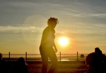 A silhouette against a beach sunset.