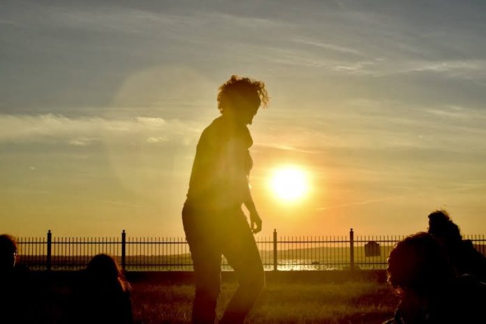 A silhouette against a beach sunset.