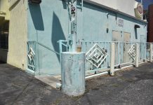A concrete outer wall of a restaurant. A small logo reads “Fatburger.”