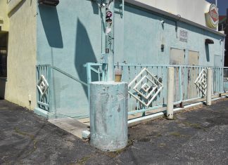 A concrete outer wall of a restaurant. A small logo reads “Fatburger.”