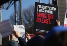 A hand holds up a sign that reads, "I'm sorry kiddo, I was wrong. Monsters do exist."