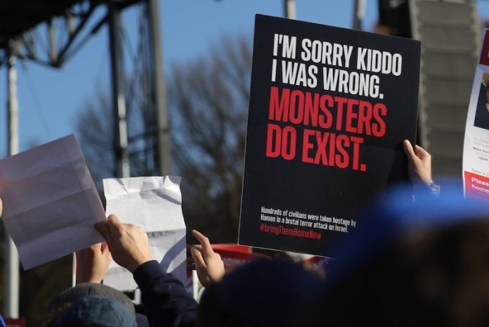 A hand holds up a sign that reads, "I'm sorry kiddo, I was wrong. Monsters do exist."