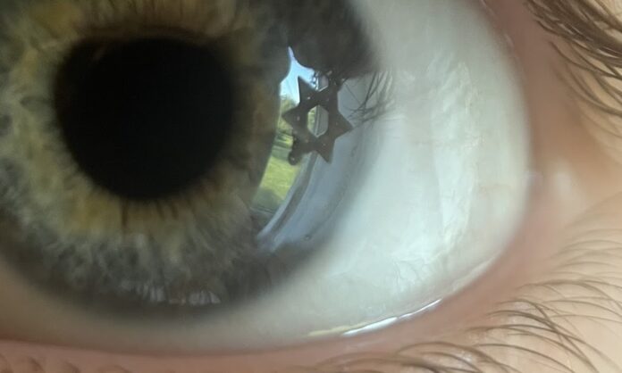 Jewish Reflection A close up of a blue eye with a Jewish star reflecting in the iris.